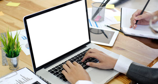 istock Businessman hands typing laptop in office with blank screen for graphic mock up 1157041557
