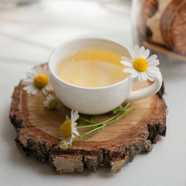 istock Cup of herbal tea and chamomile on the white table 1157045263