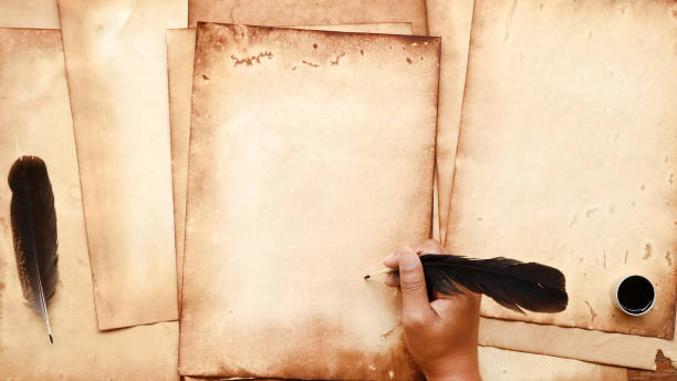 istock old paper on brown wood texture with feather and ink 1157048974