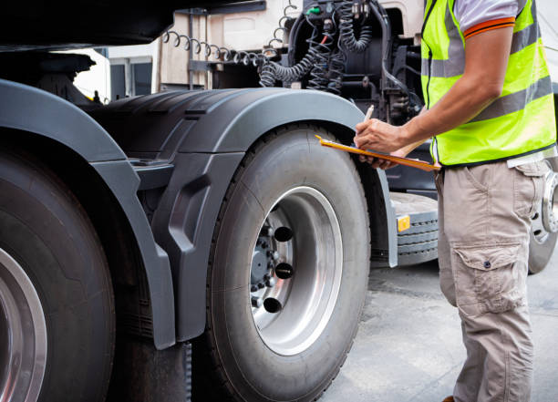 Truck inspection and safety Truck driver is inspecting check truck wheels. commercial land vehicle stock pictures, royalty-free photos & images