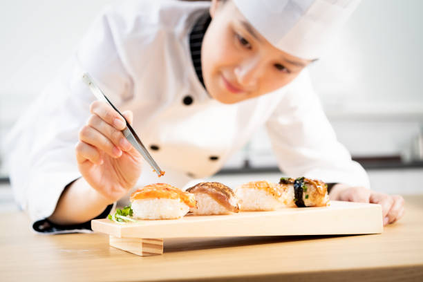 istock Asian woman decorating a sushi plate 1157051064