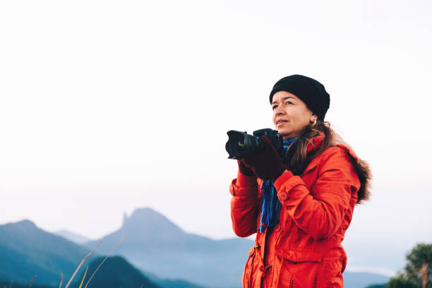 Mid adult woman photographer outdoors Mid adult woman photographer outdoors glengarry cap stock pictures, royalty-free photos & images