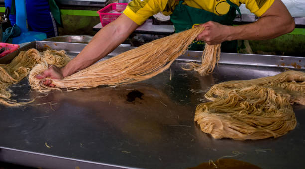 istock How to cook Roti Saimai or Thai cotton candy burrito pancake. 1157052392