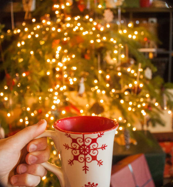istock Cup of coffee and christmas tree 1157053528