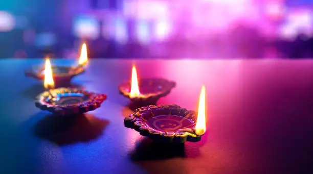 Happy Diwali - Colorful clay diya lamps lit during diwali celebration