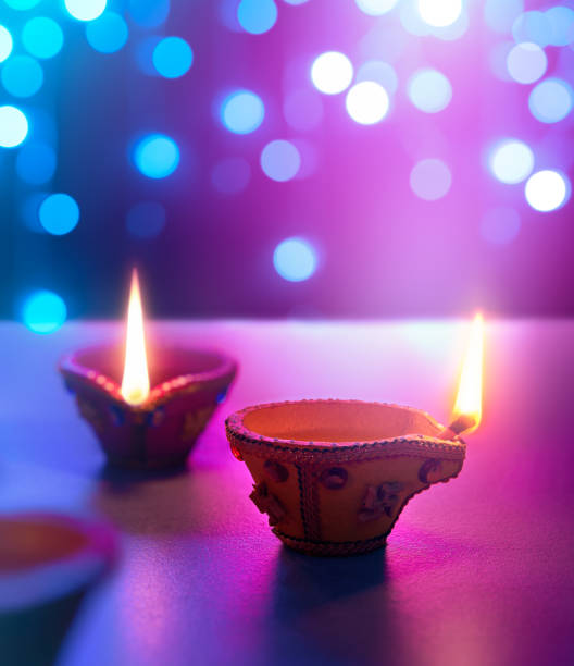 istock Happy Diwali - Diya lamps on floor with bokeh light background 1157054671
