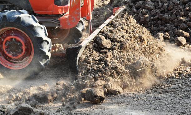 istock tractor push clot soil after pour from truck 1157057608