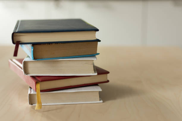 istock Stack of books on wooden table. 1157059479