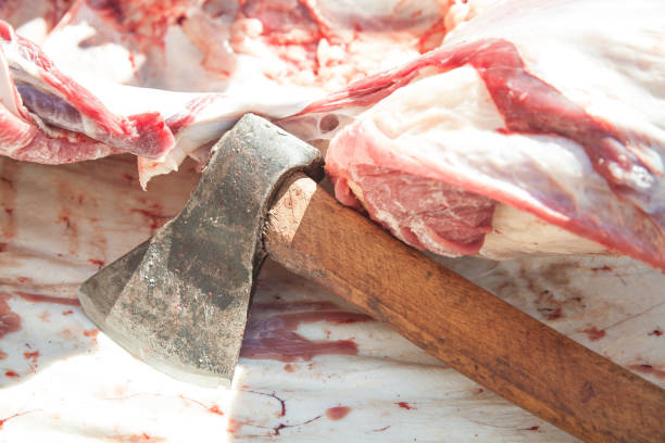 Raw meat with a ax. Cutting meat