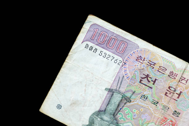 istock Outdated 1000 Korean Won note of 1983 issued on a black background close-up 1157065059