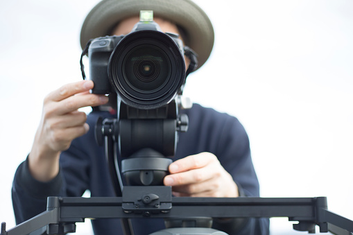 man filming with DSLR camera