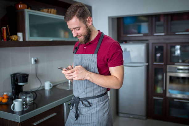 istock Happy handsome man cooking in kitchen at home. 1157067893