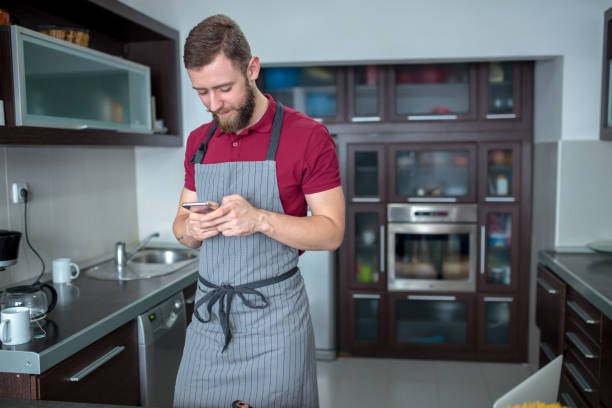 istock Happy handsome man cooking in kitchen at home. 1157067944