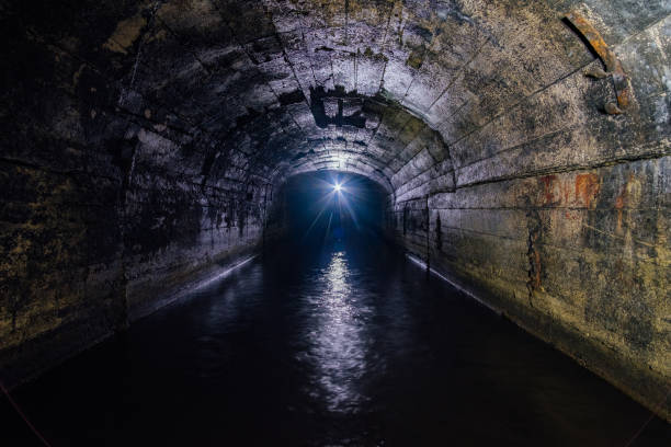 istock Dark flooded concrete vaulted drainage mine tunnel 1157067997
