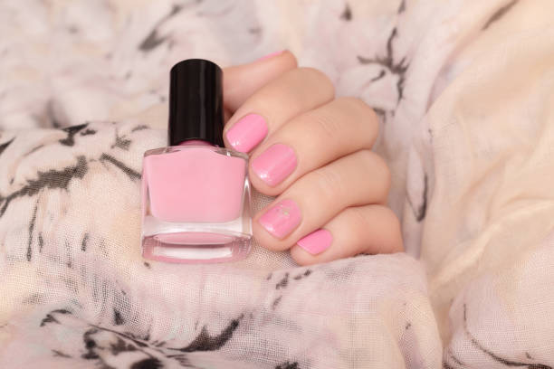 istock Female hand with pink and glitter nail design 1157071179