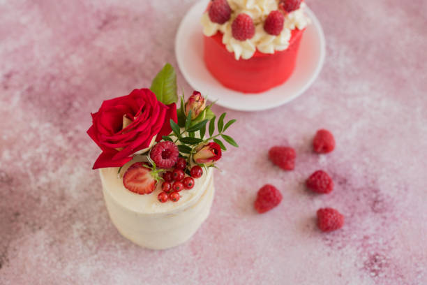 istock Beautiful pink cream and berries cake on a light concrete background 1157072703