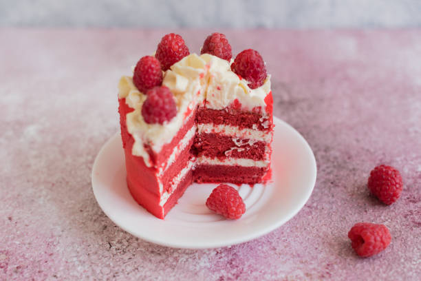 istock Beautiful pink cream and berries cake on a light concrete background 1157072952
