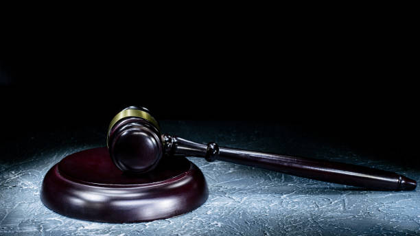 istock Judge's gavel lies on a stone table. 1157073818