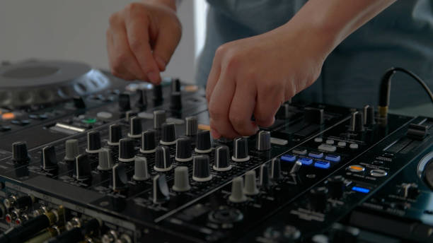 istock Young man playing with DJ decks at home. 1157074097