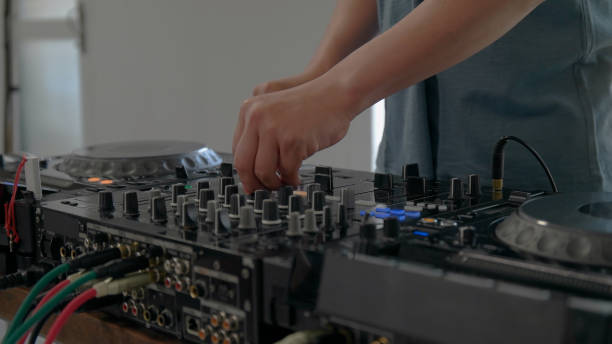 istock Young man playing with DJ decks at home. 1157074111