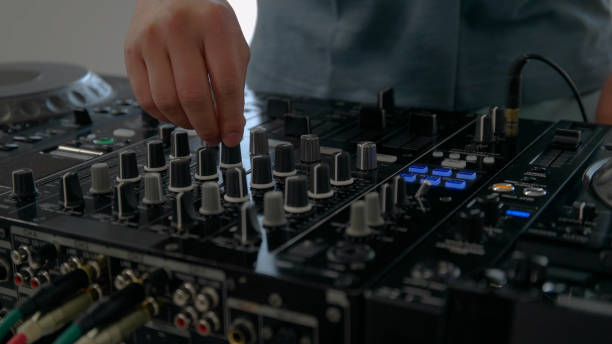 istock Young man playing with DJ decks at home. 1157074118