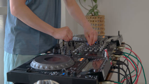 istock Young man playing with DJ decks at home. 1157074119