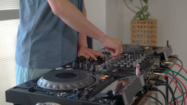 istock Young man playing with DJ decks at home. 1157074135