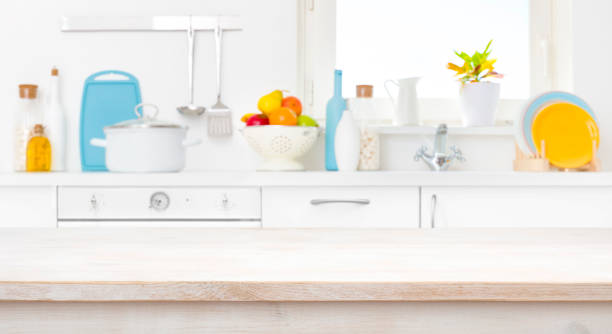 istock Bleached wooden table in front of blurred sunny kitchen window 1157074727