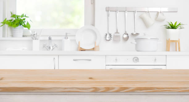 Wood table top on blur kitchen room and window background