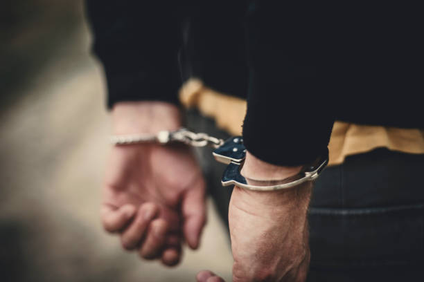 Pointing to the criminal Man in handcuffs behind his back arrest photos stock pictures, royalty-free photos & images