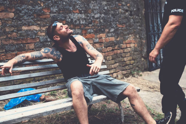 Pointing to the criminal tattooed man in a discussion with police officer drug addiction tattoos stock pictures, royalty-free photos & images