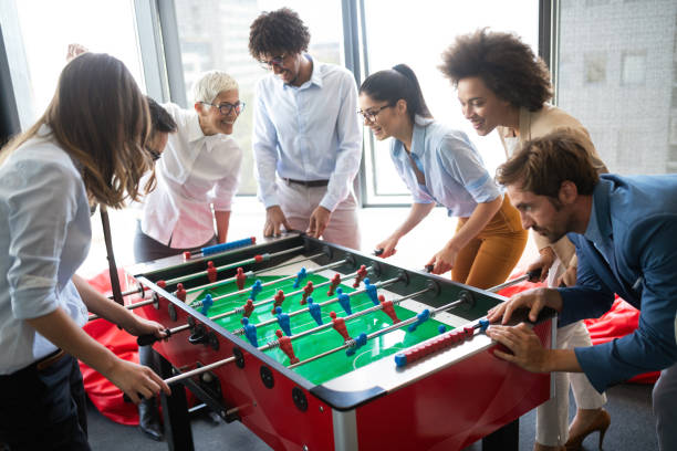 istock Coworkers playing table football on break from work 1157075400