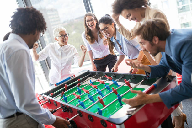 istock Multiracial people having fun in office room, excited diverse employees enjoying activity at work 1157075402