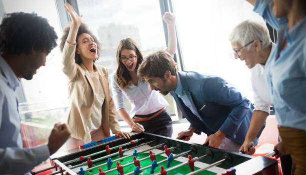 istock Excited diverse employees enjoying funny activity at work break, creative friendly workers play game 1157075438