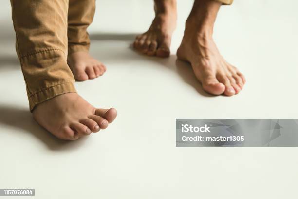 Familys Legs On White Studio Background Dad And Son Stock Photo - Download Image Now