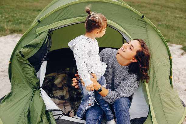 istock Mother with daughter playing in a summer park 1157078544