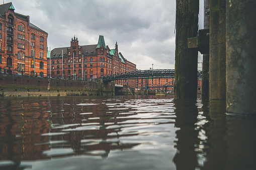 low angle view of Zollkanal channel and historic warehouses in the Speicherstadt district of Hamburg