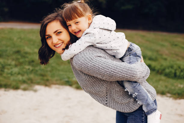 istock Mother with daughter playing in a summer park 1157079406