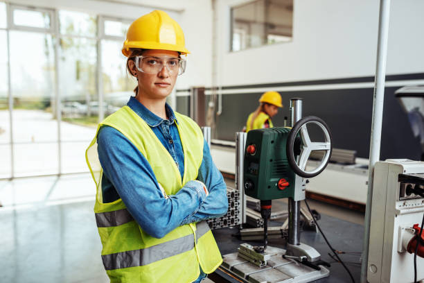 istock Female employee in protective uniform working on CNC machines. 1157079463