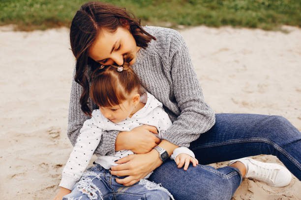 istock Mother with daughter playing in a summer park 1157079667