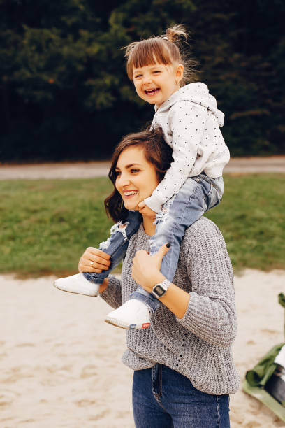 istock Mother with daughter playing in a summer park 1157080434