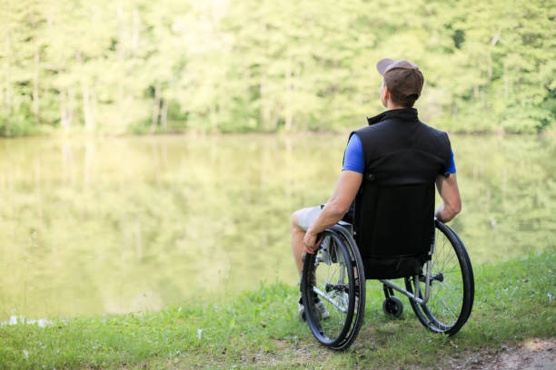 istock Disabled man on wheelchair in nature 1157084189