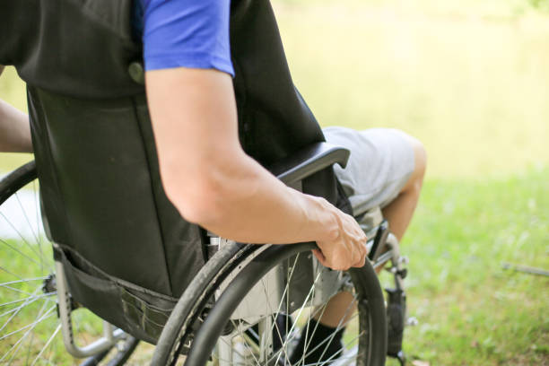 istock Disabled man on wheelchair in nature 1157084191