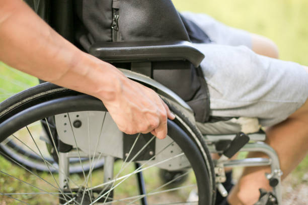istock Disabled man on wheelchair in nature 1157084251
