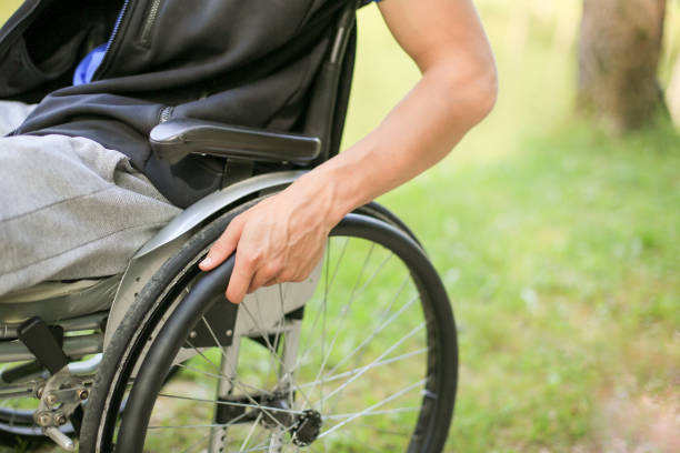 istock Disabled man on wheelchair in nature 1157084252