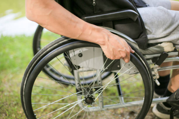 istock Disabled man on wheelchair in nature 1157084254