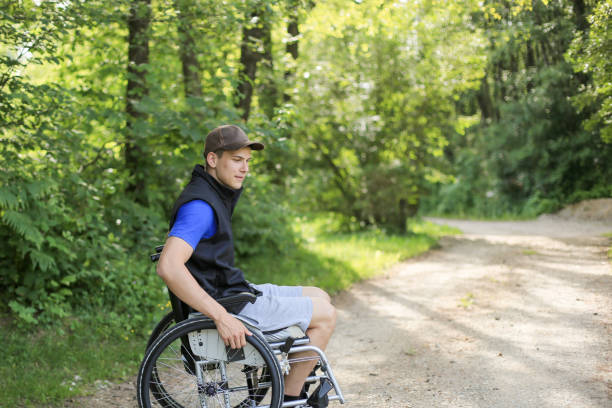 istock Disabled man on wheelchair in nature 1157084360