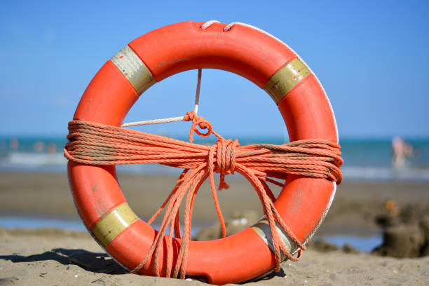 夏のビーチでの安全 - life jacket buoy sign sky ストックフォトと画像