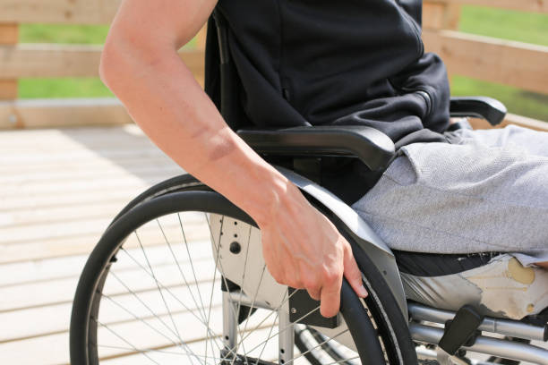 istock Disabled young man on a wheelchair 1157085076