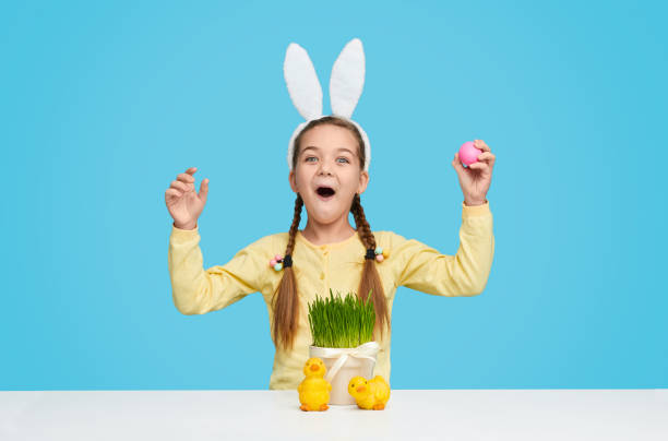 istock Amazed girl in bunny ears celebrating Easter 1157085391